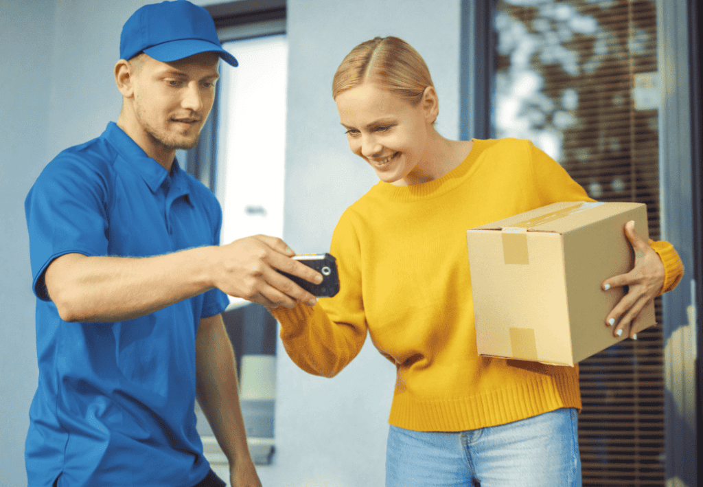 Delivery man with a recipient signing on the phone